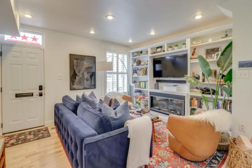 a living room with a blue couch and a tv at 2 Mi to National Mall Stunning Townhome with Patio! in Washington, D.C.