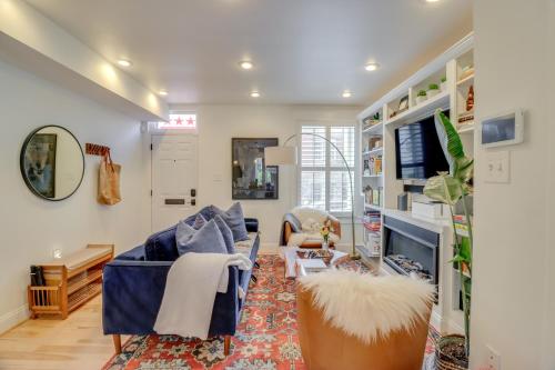 a living room with a couch and a tv at 2 Mi to National Mall Stunning Townhome with Patio! in Washington, D.C.