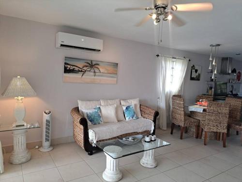 a living room with a couch and a table at Beautiful villa less than 5 minutes from the beach in Jolly Harbour