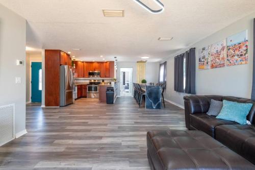 a living room with a couch and a kitchen at Cruise-Ready Oasis 15min to Beach & Port Canav & Huge Pool in Cocoa