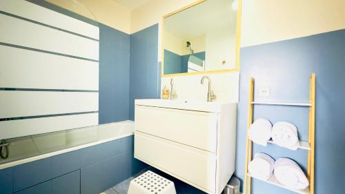 een badkamer met een wastafel en een spiegel bij Le Jardin Suspendu, Steps to Lake & Station in Bussy-Saint-Georges