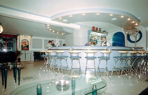 a bar in a restaurant with bar stools at Saint George Borovets Hotel in Borovets