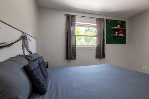 a bedroom with a bed and a window at Cruise-Ready Oasis 15min to Beach & Port Canav & Huge Pool in Cocoa