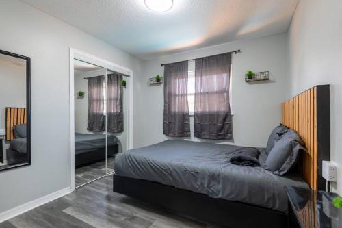 a bedroom with a bed and a mirror at Cruise-Ready Oasis 15min to Beach & Port Canav & Huge Pool in Cocoa