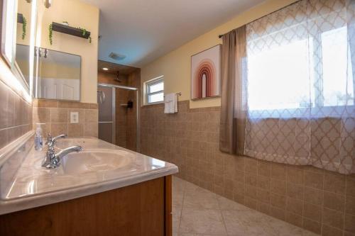 a bathroom with a sink and a shower at Cruise-Ready Oasis 15min to Beach & Port Canav & Huge Pool in Cocoa