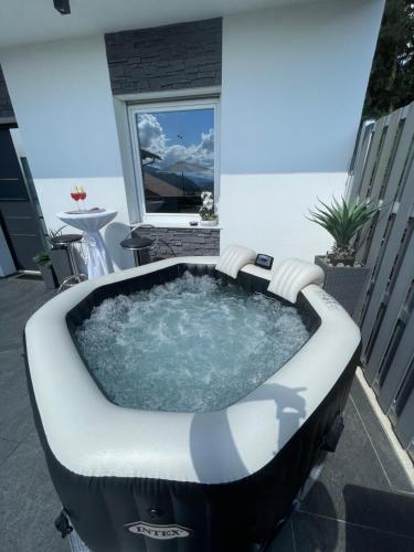 a jacuzzi tub sitting on a balcony at Apartmenthaus am Seeblick in Feldkirchen in Kärnten