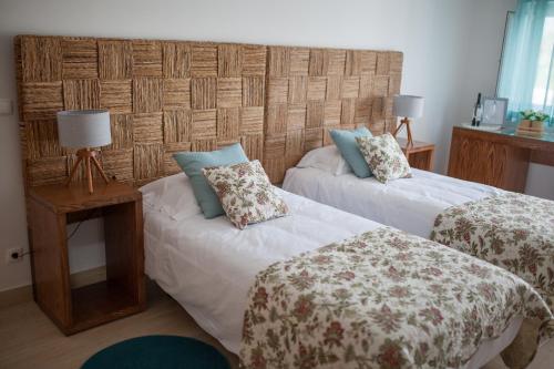 a bedroom with two beds with pillows on them at Quinta da Sardinha in Elvas