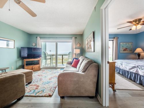 a living room with a couch and a bed at Sands III #2B - A BluSea in Carolina Beach