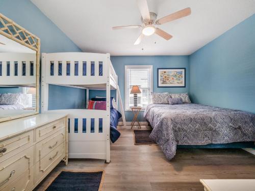 a bedroom with two bunk beds and a ceiling fan at Sands III #2B - A BluSea in Carolina Beach