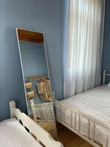 a bedroom with a bunk bed and a mirror at Traditional maisonette just 15' from Kalamata in Valíra