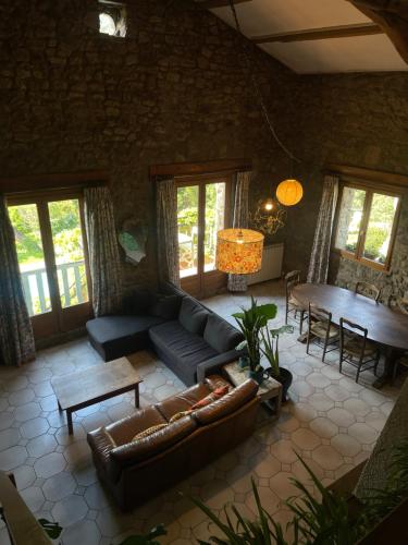 a living room with a couch and a table at Gites de Gobertier in Saint-Alban-dʼAy