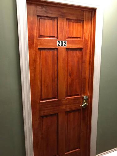 a wooden door with the number on it at 202 Private Room-Double Twin Bed in CoHi DC! in Washington