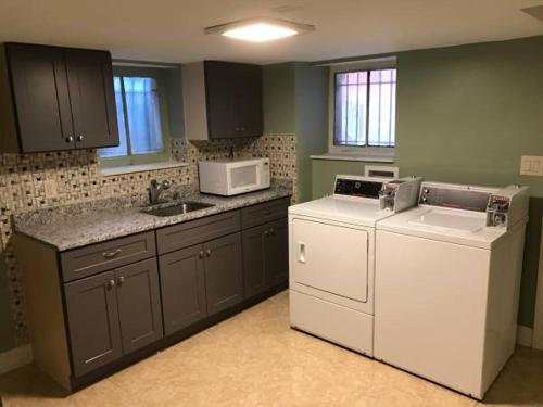 a kitchen with a dishwasher and a washer and a microwave at 202 Private Room-Double Twin Bed in CoHi DC! in Washington
