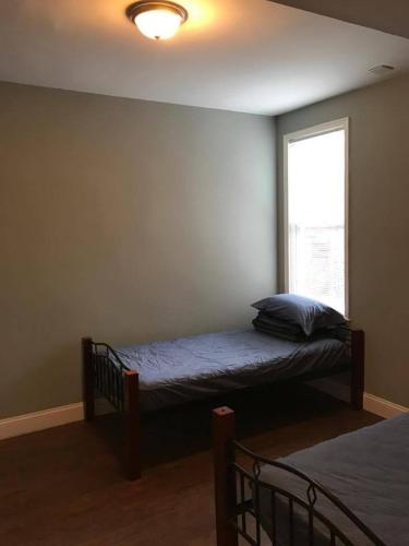 a bedroom with a bed and a window at 202 Private Room-Double Twin Bed in CoHi DC! in Washington