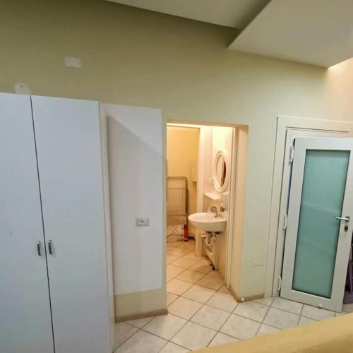 a bathroom with a toilet and a sink at Spillo Short Rent Affitti brevi in Due Carrare