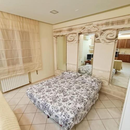 a bedroom with a bed and a large mirror at Spillo Short Rent Affitti brevi in Due Carrare