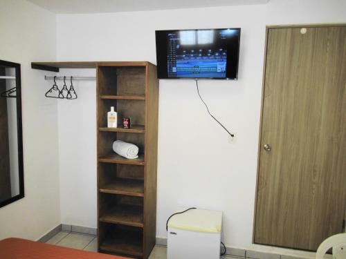 a room with a tv hanging on the wall at Cocos in Cancún