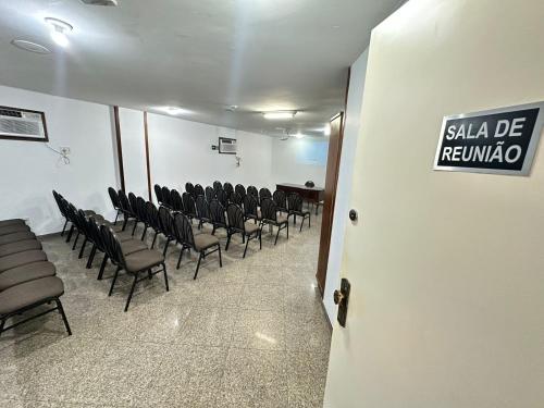 a row of chairs in a room with a table at César Park Hotel in Juiz de Fora