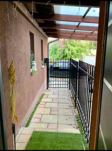 an outside walk way with a fence and grass at Luxury Villa with Pool close to the Hungaroring in Kerepes