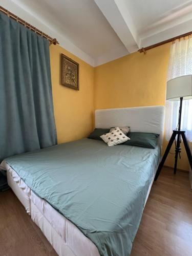 a bedroom with a bed with a green blanket at Siedlisko Opoka okolice Sandomierza i Kazimierza Dolnego in Opoka Duża