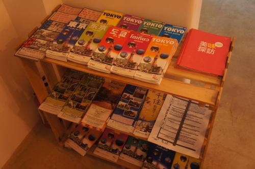 a wooden table with magazines on top of it at Sato-san's Rest in Tokyo