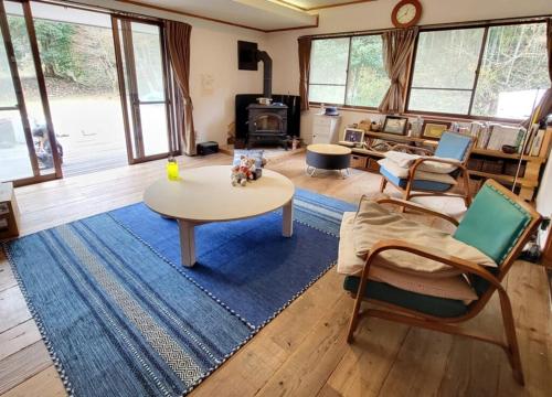 a living room with a table and chairs and a couch at Villa Mountainman - Vacation STAY 23090v in Ichijuku