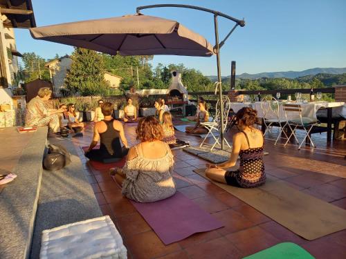 a group of people sitting on a patio doing yoga at La Casa di Bacco B&B in Lerma
