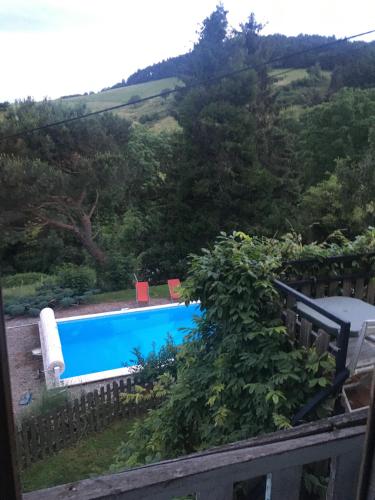 a view of a swimming pool from a fence at Gites de Gobertier in Saint-Alban-dʼAy