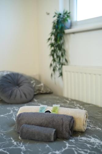 a towel sitting on top of a bed at Immaculate Condition 3 Bed En-Suite Refurbished House in Goodmayes