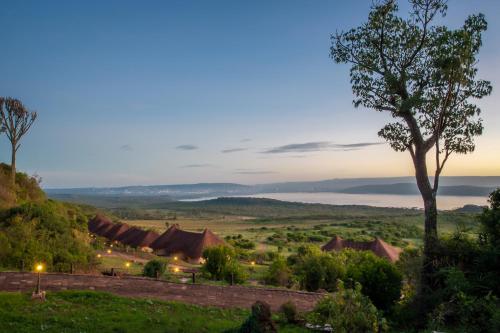 a view of a village with a tree in the foreground at Lake Nakuru Sopa Lodge in Nakuru
