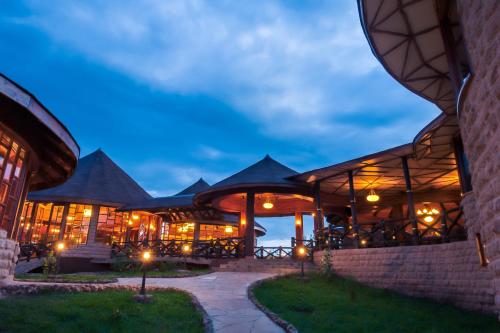 a building with lights on it at night at Lake Nakuru Sopa Lodge in Nakuru