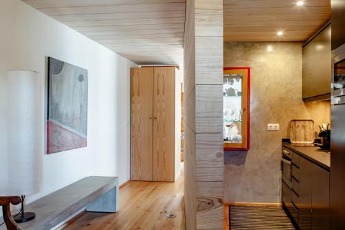 a kitchen with white walls and wooden flooring at Casas da Fontanheira in Marvão