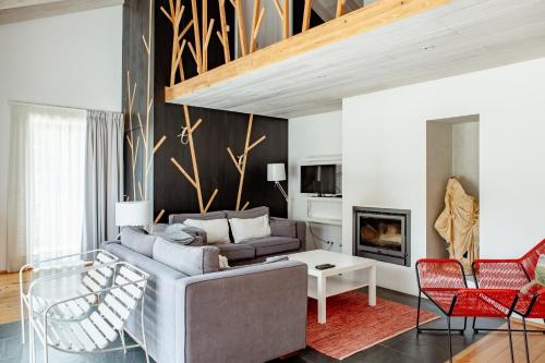 a living room with a couch and a fireplace at Casas da Fontanheira in Marvão