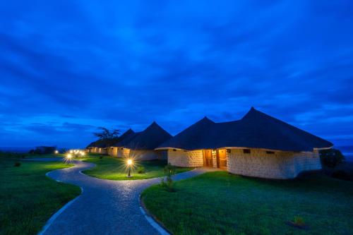 a row of lodges at night with a pathway at Lake Nakuru Sopa Lodge in Nakuru