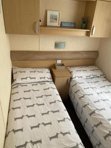 a bedroom with two beds in a small room at Holiday home in Furzehill in Wimborne Minster
