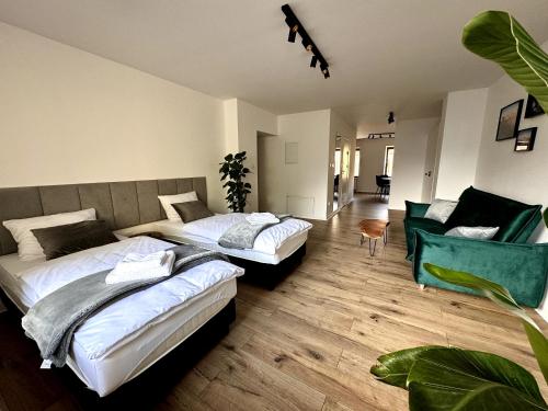 a bedroom with two beds and a couch at Sweet Apartments in Żarki