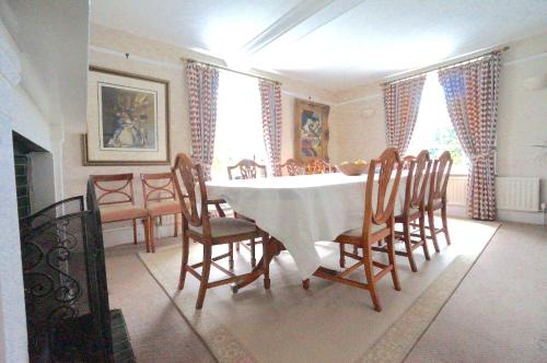 a dining room with a table and chairs at Colthrop Manor with Gardens in Thatcham