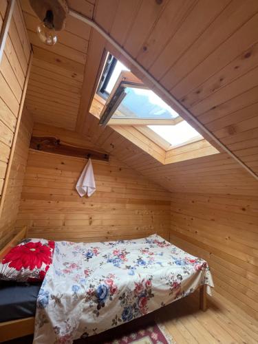 a bed in a room with a window at Shpia e Las Vol in Vasije