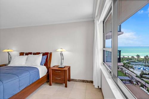 a bedroom with a bed and a view of the ocean at 2 Bedrooms Unit OceanFront Resort The Alexander in Miami Beach
