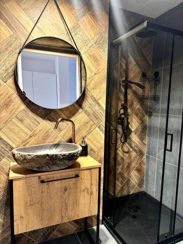 a bathroom with a sink and a mirror at Sweet Apartments in Żarki
