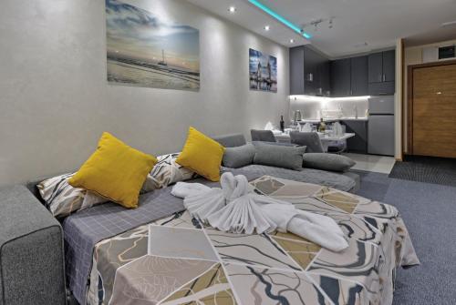 a living room with a bed and a kitchen at Lux Mila with Free Private parking in Novi Sad