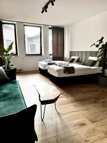 a living room with two beds and a couch at Sweet Apartments in Żarki