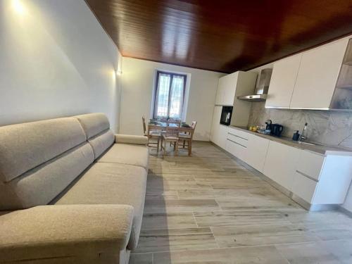 a living room with a couch and a table at Appartamento sul Lago - MEINA in Meina