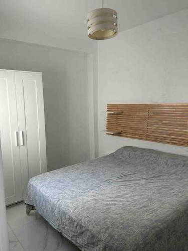 a bedroom with a bed in a white room at Chalet a 2 metros de la playa in Rota
