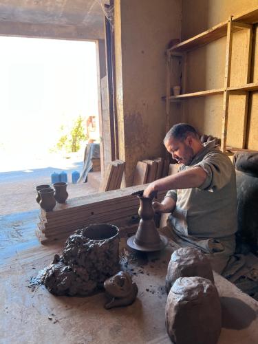 a man making a vase on a pottery wheel at Tazart Lodge in Marrakech