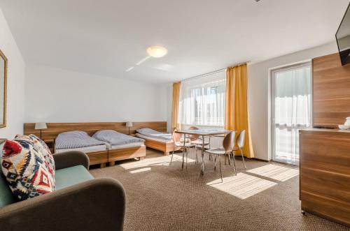 a living room with a couch and a table at Złota 24 in Karwia