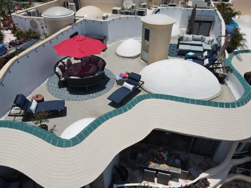 an overhead view of a pool with an umbrella at Ocean Front, With Pool, 6 People, Quinta del Mar PH502 in Bucerías