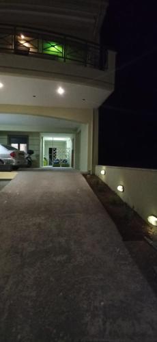 an empty parking lot of a building at night at AXD Evangelia's apartment in Alexandroupoli