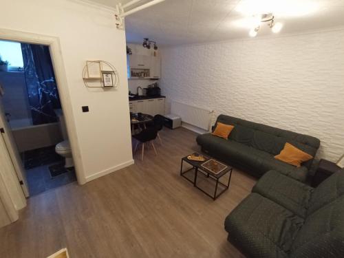 a living room with a couch and a table at Black Diamond Lux - deluxe riverside apartment in Senta