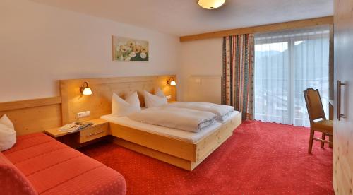 a hotel room with a bed and a window at Haus Christina in Serfaus